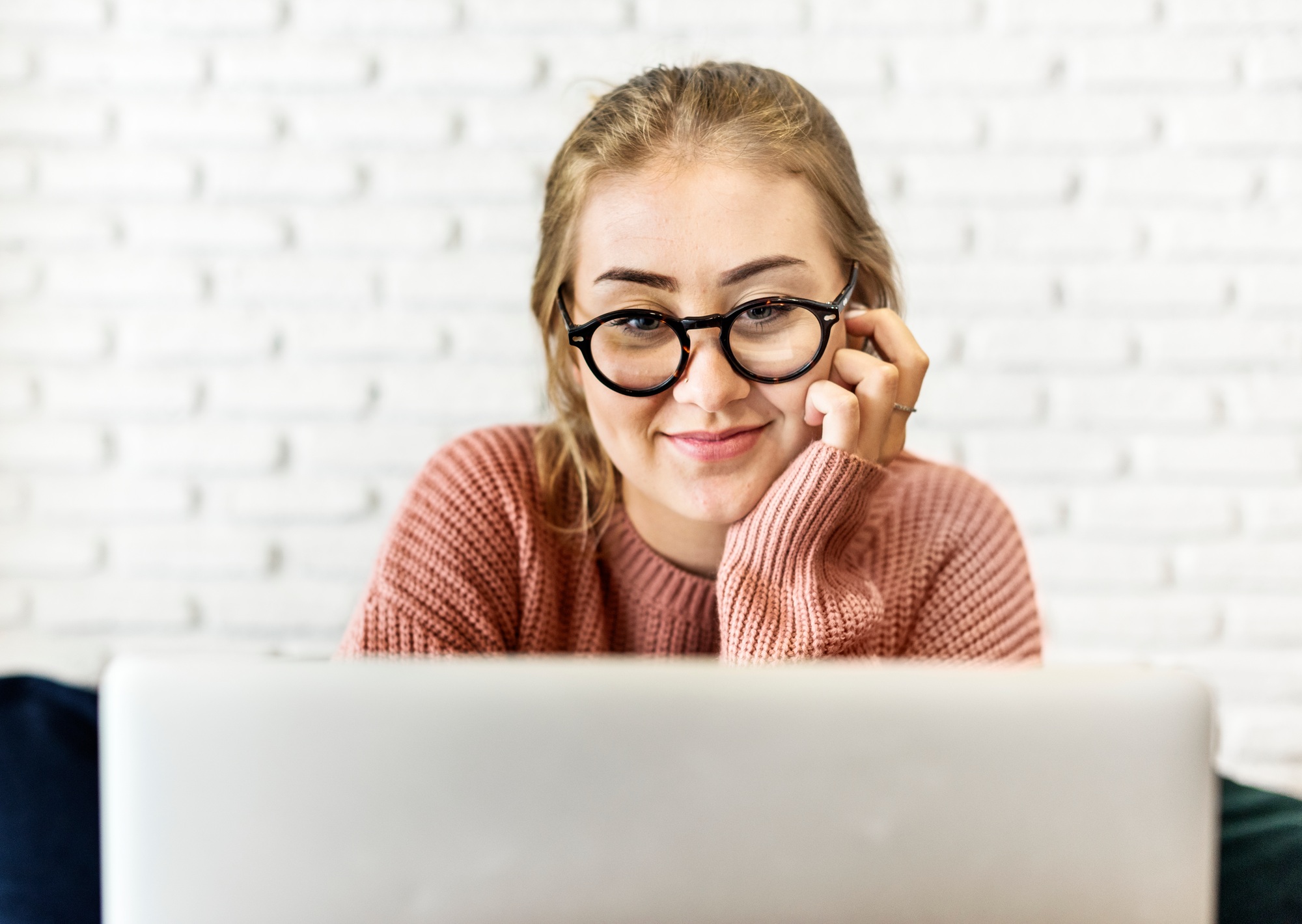 Cheerful young woman using laptop