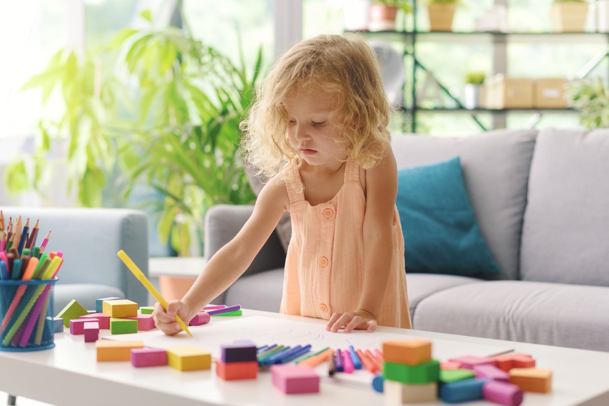 Cute girl coloring with markers