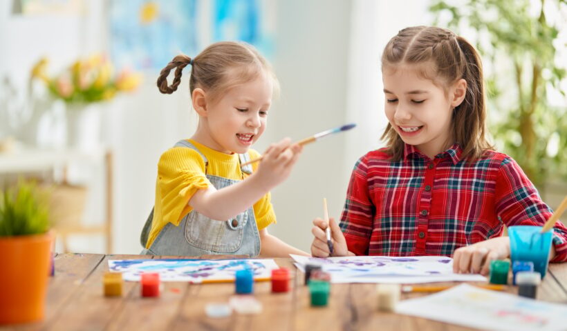 Happy kids are painting at home.