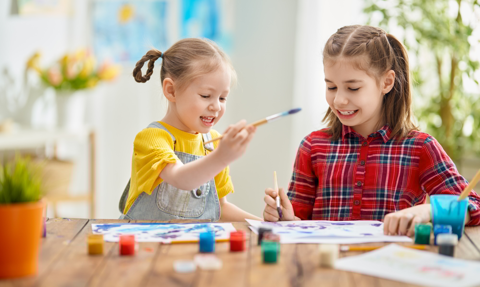 Happy kids are painting at home.